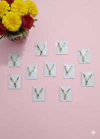 Diamond Crystal Haar Necklace for Laddu Gopal Pack of 11 - Sparkling rhinestone V-shaped necklaces with gemstone pendants on pink background